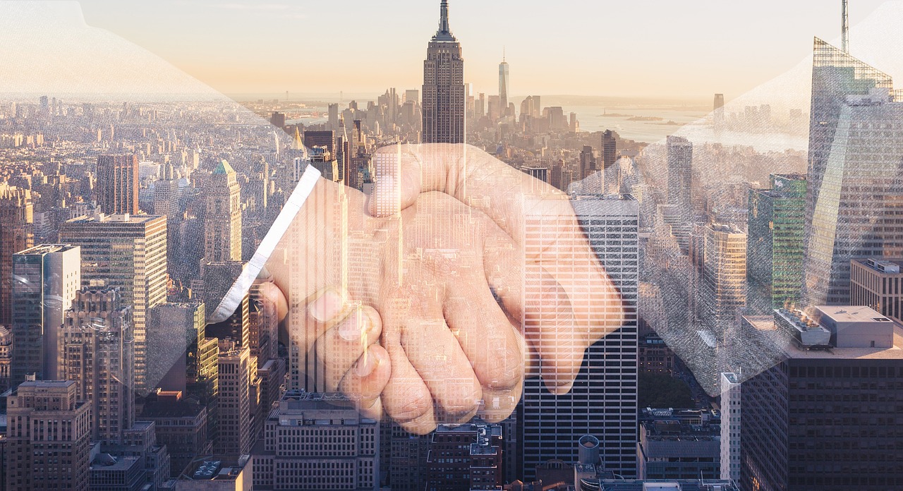 Employer and recruitment partner shaking hands in a meeting room